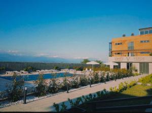 a resort with a swimming pool and a building at Verde Resort in Ikalto