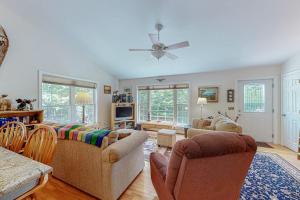 a living room with couches and a ceiling fan at Inviting dog-friendly home with firepit & Ping-Pong - near Acadia National Park in Ellsworth