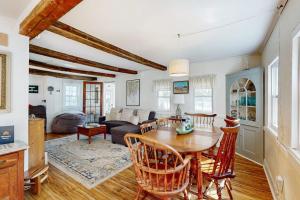 a dining room and living room with a table and chairs at Charming Boothbay Harbor cottage with partial AC, full kitchen, and sun room in Boothbay Harbor
