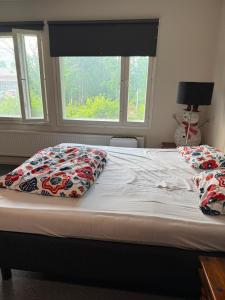 a bed with two pillows on it with a window at YKI Room in Oulu