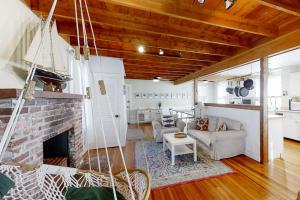 a living room with a brick fireplace and a couch at Historical New England home, outdoor shower , Dog-friendly in Boothbay Harbor