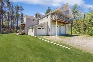 a house with a large yard in front of it at Modern farmhouse with deck, firepit, & balcony in Northport