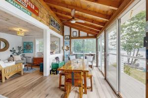 a dining room and living room with a wooden table at Charming Oceanfront Home with Stunning Water Views and Wifi in Georgetown +11 photos