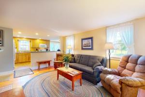 a living room with a couch and a table at Comfortable home near the beach - dog-friendly - full kitchen & washer/dryer in Rockland