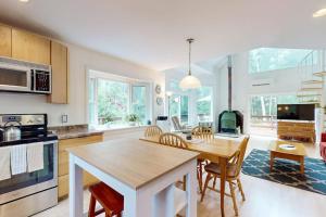 a kitchen and dining room with a table and chairs at Sunny coastal retreat with deck, grill, beach, dock, & ocean access in East Boothbay +17 photos