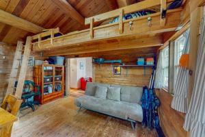a living room with a couch and a loft at The Cottage - Peaceful 32-Acre Lakefront Getaway - Canoe, Firepit & Big Deck in Franklin