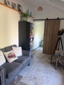 a living room with a couch and a closet at Ty Lochois in Loches