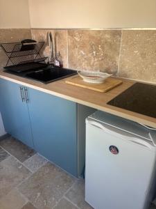 a kitchen with a sink and a counter top at Ty Lochois in Loches