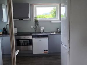 a small kitchen with a sink and a window at Fjordside Apartment in Åndalsnes
