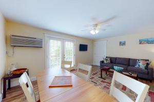 a living room with a table and a couch at Stylish Condo at Sheepscot Harbor Resort w/Free WiFi, River Views, & Balcony in Edgecomb