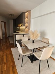 a dining room with a table and chairs at La Casa in Livno +4 photos