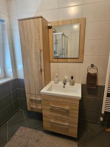 a bathroom with a sink and a mirror at La Casa in Livno