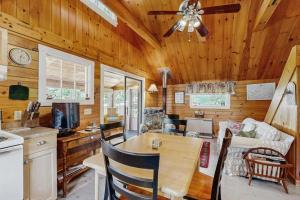 a kitchen and living room with a wooden ceiling at Lakefront, cabin-inspired home with firepit, grill, & screened porch, Wifi in Greenville