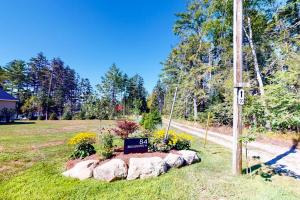 a sign in a yard with some rocks at Newly-built waterfront home with fast WiFi, furnished deck, & washer/dryer in Waldoboro