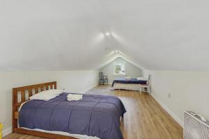 a bedroom with a large bed in a attic at Modern farmhouse with deck, firepit, & balcony in Northport