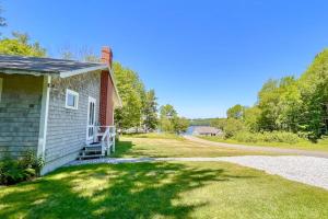 a small house with a porch and a driveway at Classic home overlooking the St George River with deck & great views in Saint George