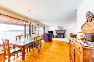 a kitchen and dining room with a table and chairs at Waterfront home with beautiful bay views - near shops & dining in Owls Head