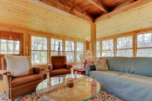a living room with couches and a glass table at Charming Bayview Cottage with Deck, Firepit, Garden - 200 in East Harpswell