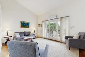 a living room with two couches and a table at Dog-Friendly Townhouse w/Bay Views, Fast WiFi, and Partial A/C in Bar Harbor