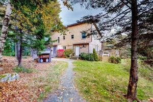 a house with a path in front of a yard at Dog-friendly ocean-view duplex with wood stoves, decks, grills, kitchens, ACs in Southwest Harbor