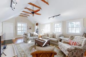 a living room with couches and a ceiling fan at Historical New England home, outdoor shower , Dog-friendly in Boothbay Harbor