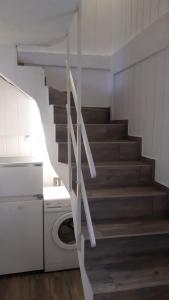 a staircase in a kitchen with a washing machine at Apartments Rainbow in Pörtschach am Wörthersee +44 photos