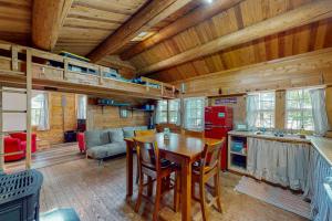 a kitchen and living room with a wooden ceiling at The Cottage - Peaceful 32-Acre Lakefront Getaway - Canoe, Firepit & Big Deck in Franklin +17 photos