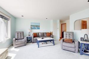 a living room with a couch and two chairs and a table at Charming Lakefront House with Outdoor Firepit, Washer/Dryer and Wifi in Gouldsboro