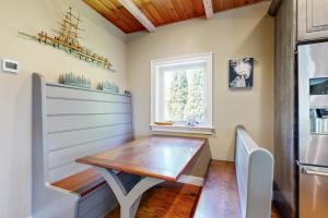a dining room with a wooden table and a window at Dog-friendly home with high-speed WiFi, washer/dryer, & private dock in Cundys Harbor +25 photos