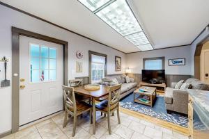 a living room with a table and a couch at Open layout Maine cottage with washer/dryer & grill - dog-friendly in Gouldsboro