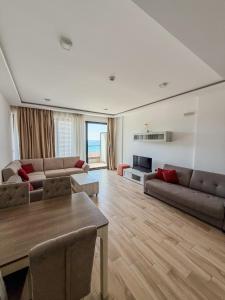 a living room with a couch and a table at Val Lux Apartmani in Sutomore