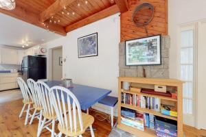a kitchen and dining room with a blue table and chairs at Home with deck, great location in the heart of Acadia National Park in Otter Creek