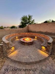 a fire pit in a patio with lights at Hemin's Greenery Villa in Erbil