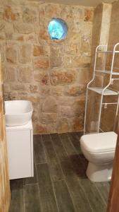 a bathroom with a toilet and a sink at Khalle Lodge in Dayr al Qamar +39 photos