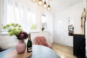 a room with a table with a bottle of wine and flowers at Fövenyes Hideaway in Balatonudvari +30 photos