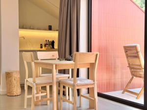 a kitchen with a table and two chairs at Grota Lodging in Leiria