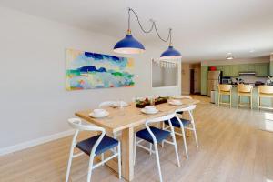 a kitchen and dining room with a table and chairs at Water-view retreat with beach access, deck, grill, EV charger & lawn games in North Harpswell