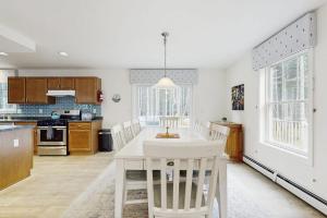 a kitchen with a white table and chairs at Secluded Dog-Friendly Getaway w/ Free WiFi, Private Washer/Dryer, Furnished Deck in Southport