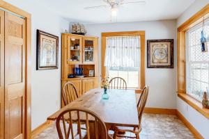 a dining room with a wooden table and chairs at Two-story home steps from Laite Beach - stroll to the harbor, 1 dog welcome in Camden +20 photos