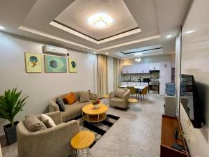 a living room with a couch and a table at Appartements Rebero Hills in Kigali