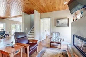 a living room with a couch and a chair and a tv at Dog-friendly home with high-speed WiFi, washer/dryer, & private dock in Cundys Harbor