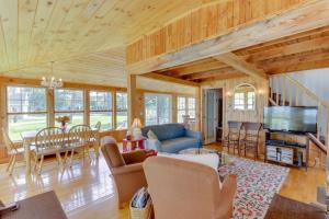 a living room with a couch and a table at Charming Bayview Cottage with Deck, Firepit, Garden - 200 in East Harpswell