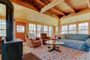 a living room with a couch and a stove at Charming Bayview Cottage with Deck, Firepit, Garden - 200 in East Harpswell +23 photos