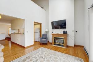 a living room with a fireplace and a tv at Townhome w/ Bonus Loft, High-Speed WiFi, Partial AC & Full Kitchen in Bar Harbor