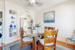 a dining room with a wooden table and chairs at Admiral's Quarters in Boothbay Harbor