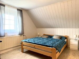 a bedroom with a bed and a window in it at Cozy Family Retreat in a Quiet Village in Křešín