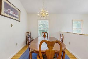 a dining room with a wooden table and chairs at Family & Dog-Friendly Townhouse w/Back Porch, Views, Partial AC in Bar Harbor