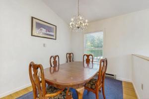 a dining room with a wooden table and chairs at Family & Dog-Friendly Townhouse w/Back Porch, Views, Partial AC in Bar Harbor +18 photos