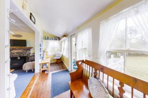 a living room with a bench and a window at Dog-friendly Fisher Hill home with patio and wood stove - walk to the harbor in Boothbay Harbor