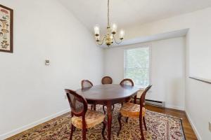 a dining room with a wooden table and chairs at Dog-Friendly Townhouse w/Bay Views, Fast WiFi, and Partial A/C in Bar Harbor +12 photos